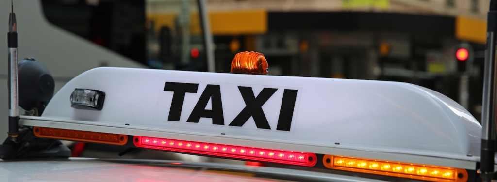 taxi car roof signage with red and orange lights
