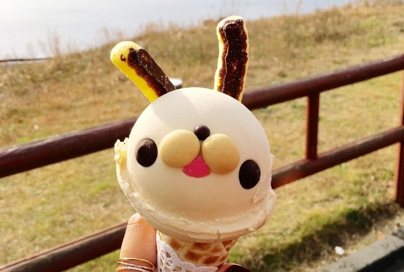 Vanilla Icecream in cone with with lollies added as eyes, mouth and ears to look like a rabbit