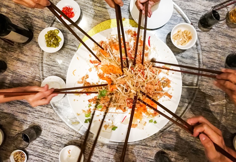 People sharing a meal with chopsticks 