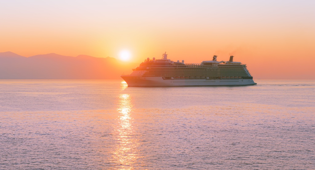 Cruise ship sailing through the sunset