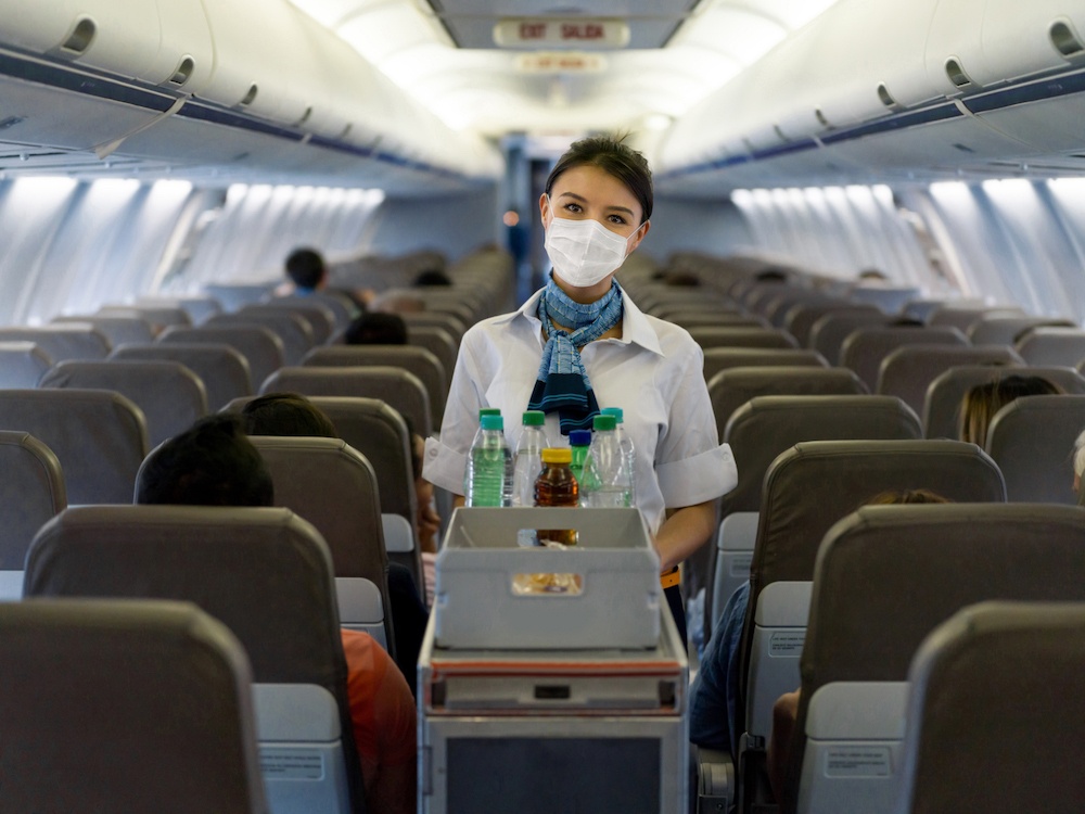 Flight attendant serving drinks 
