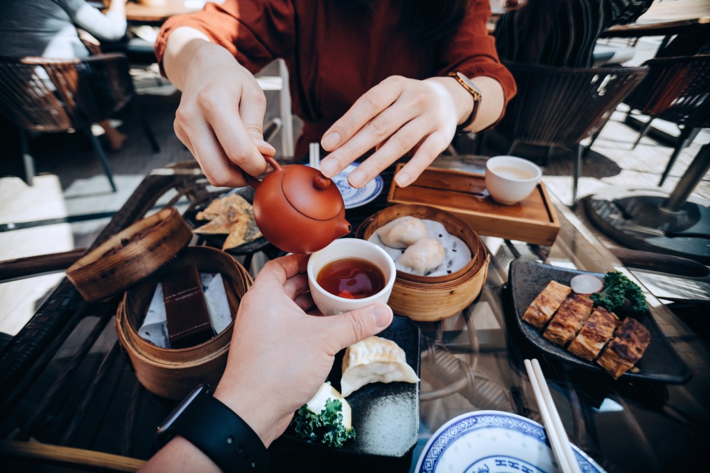 People Enjoying Chinese food while having tea