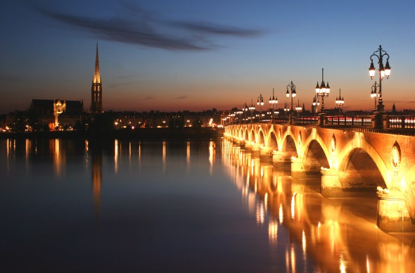 Pont de Pierre bridge lit up at night 
