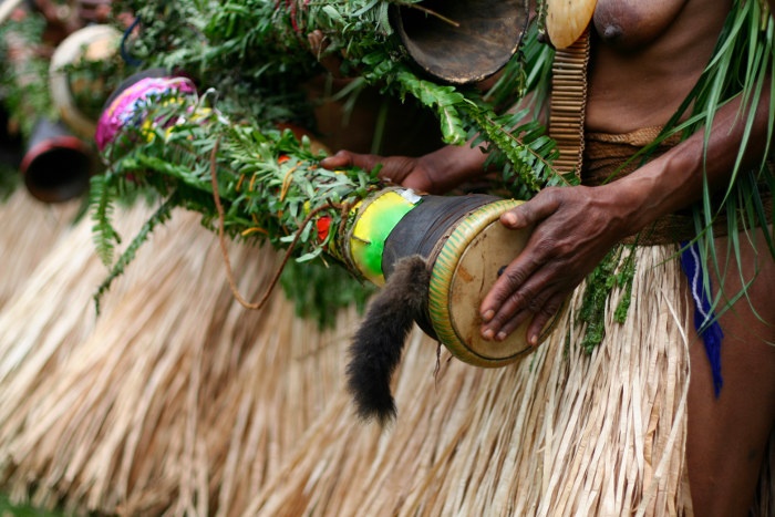 papua new guinea tribesman playing drum