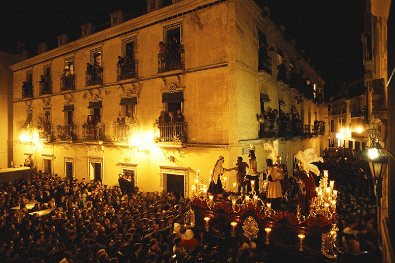 float and procession of people in seville street in spain