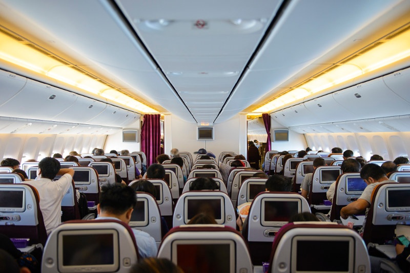 Commercial plane interior with passengers inside