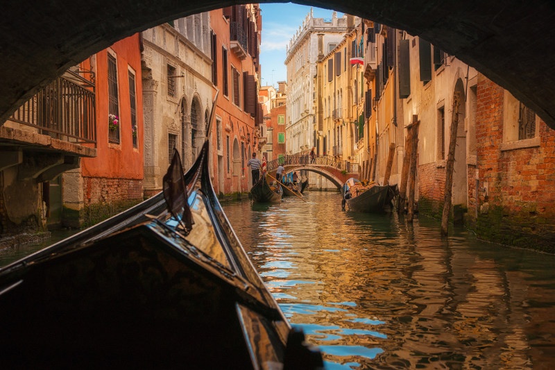 gondola under bridge in Venice, Italy