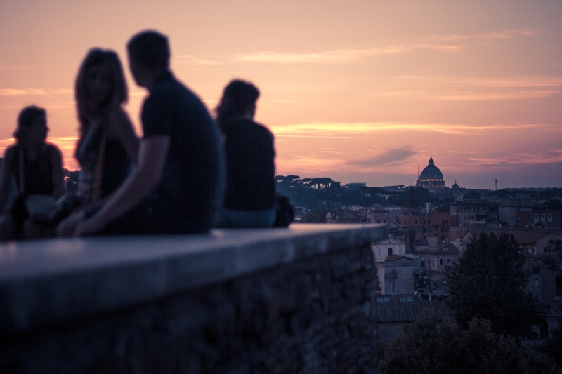 people looking at view of rome at sunset
