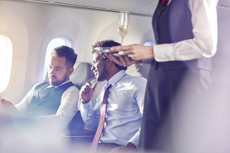 Two men having a discussion inside an airplane