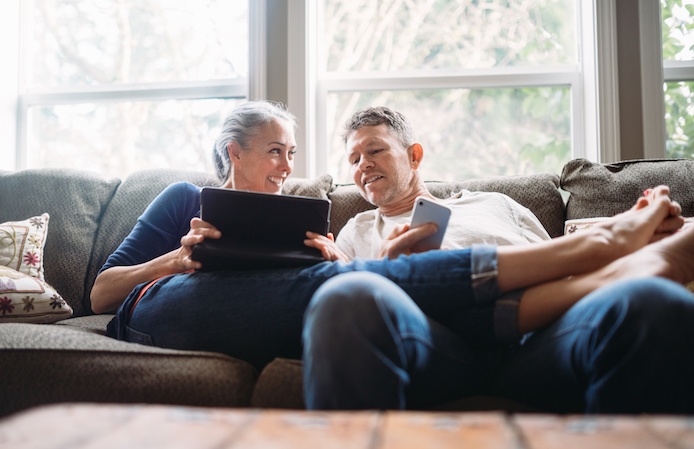 Couple on the couch on their phones 