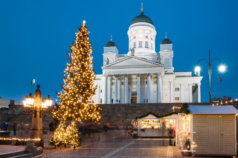 The Helsinki Cathedral in lit up at night, a few stalls below