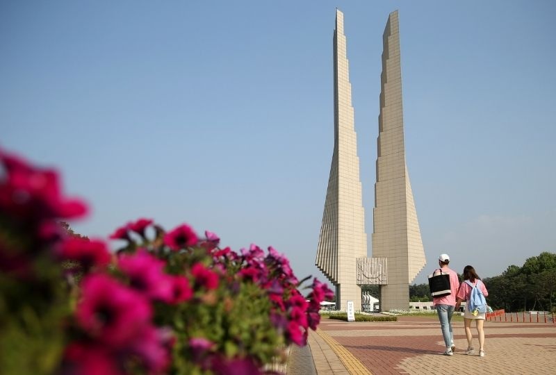 two people walk toward the Independence Hall Of Korea  