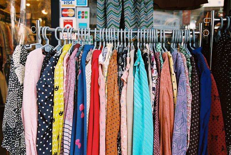 Clothing rack of a vintage store in Koenji is filled with colorful tops