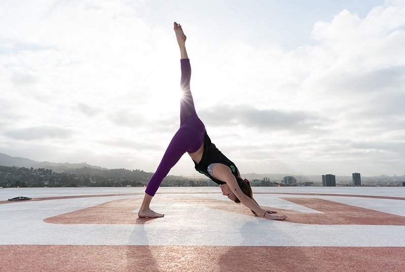 Women doing yoga pose on a helipad in LA