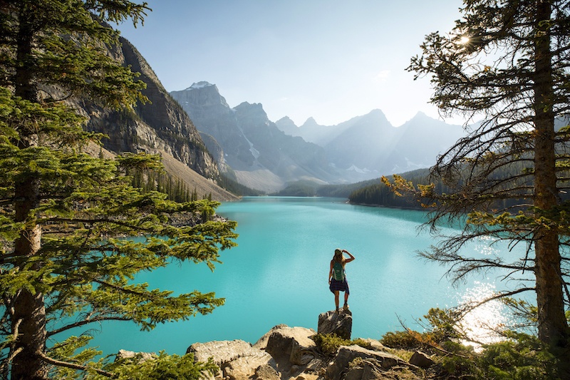 a woman basking in the sun while admiring the beautiful lake moraine