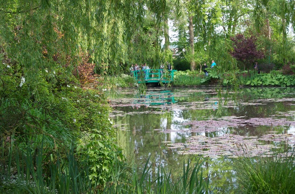 A footbridge and waterlilies at Monet's Gardens in Giverny, France.