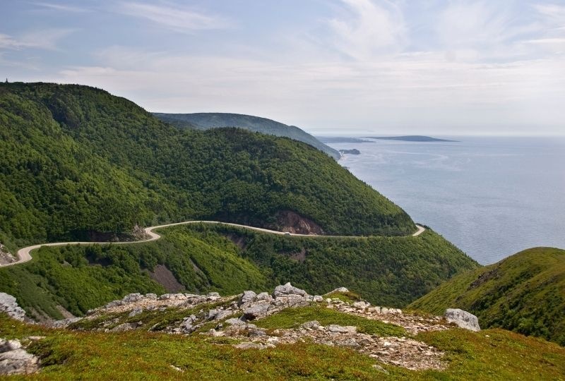 Image of a winding road next to the ocean, nova scotia.