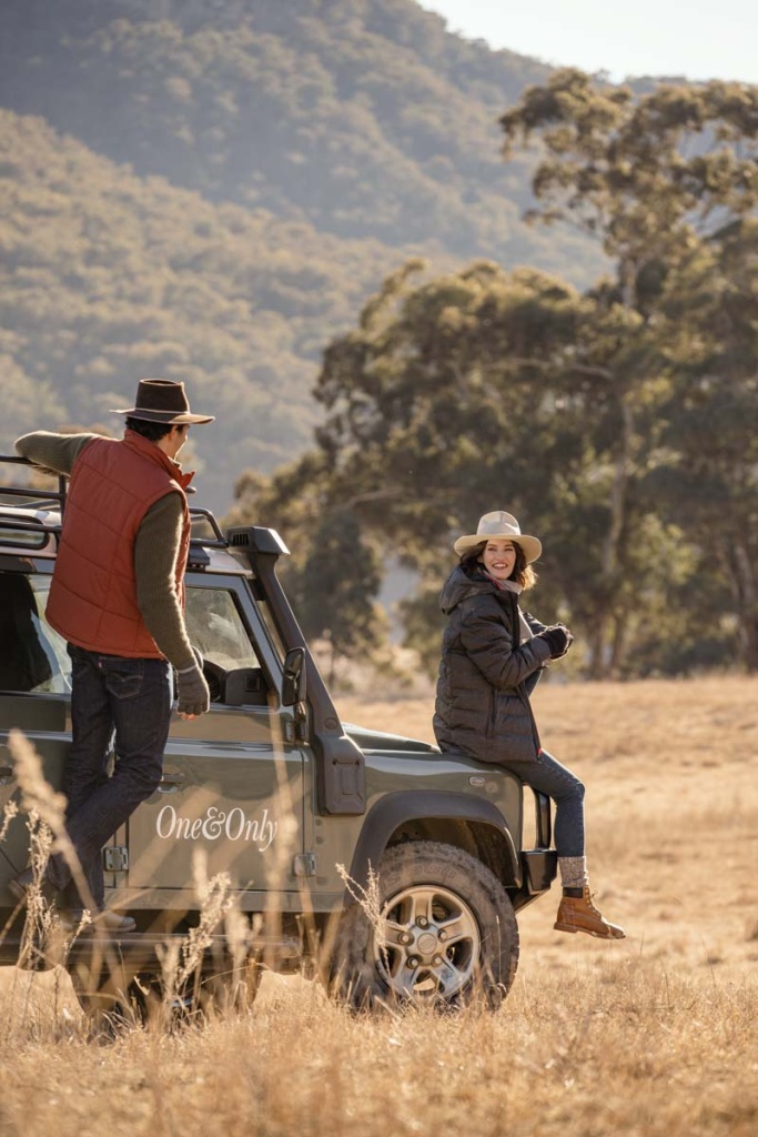 Couple parked in the field for their safari adventure