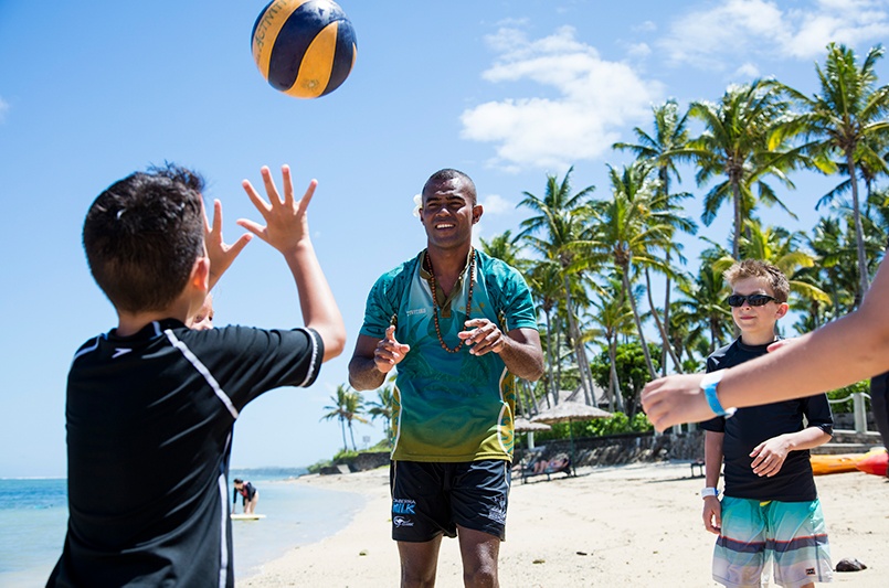Kids playing ball on the beach at Outrigger Fiji Beach Resort