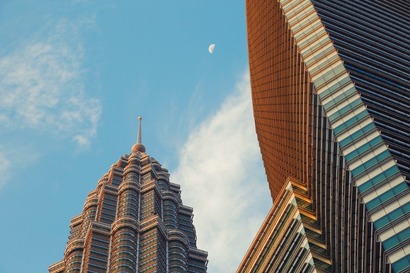 A view of the Petronas Twin Towers in Kuala Lumpur, Malaysia, highlighting its shape of an eight-pointed star.