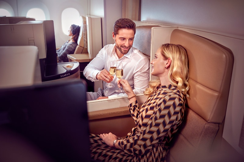 couple sharing champagne Business Class Etihad Airways