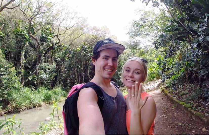 Amy and morgan taking a selfie. amy holding up her hand with the ring on. 