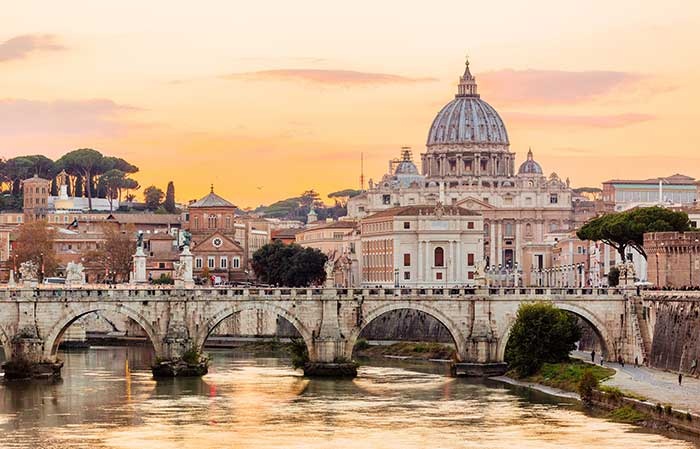 Rome skyline at sunset with Tiber river and St. Peter's Basilica, Italy