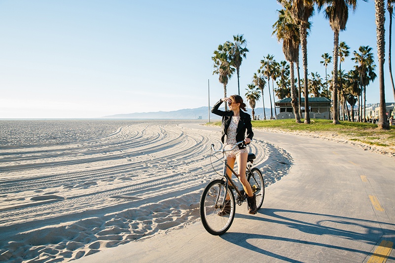 Woman cycling on Santa Monica trail