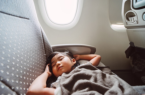 young girl asleep on the plane 