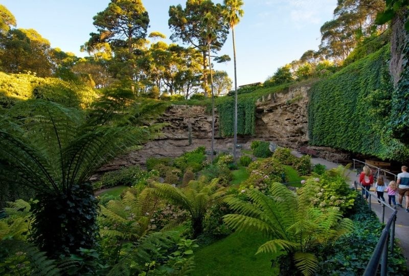  Family of four holding hands on the path viewing the Sunken Garden