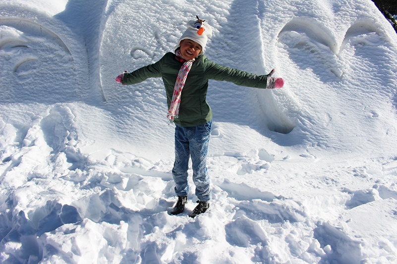 Child in snow at Grouse Mountain in winter
