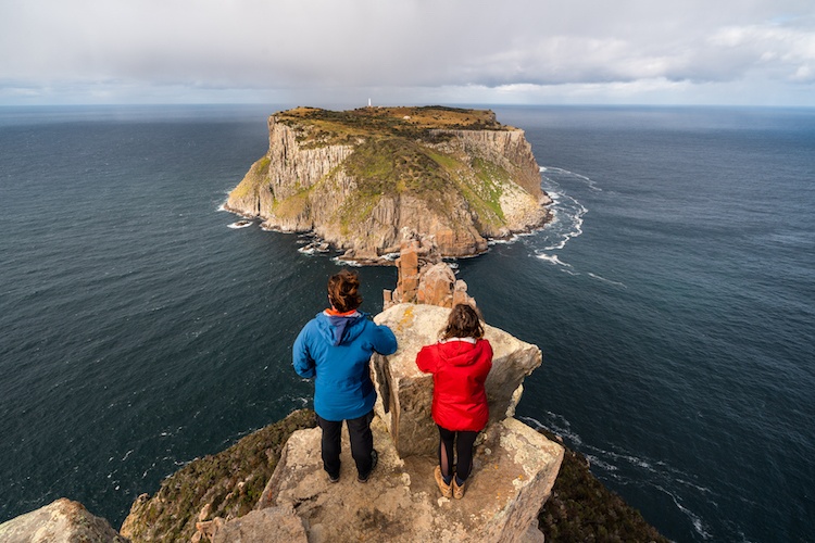 Couple enjoying the ocean view on a mountain top