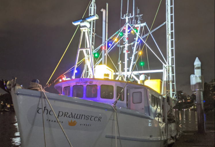 The prawnster boat lit up at night 