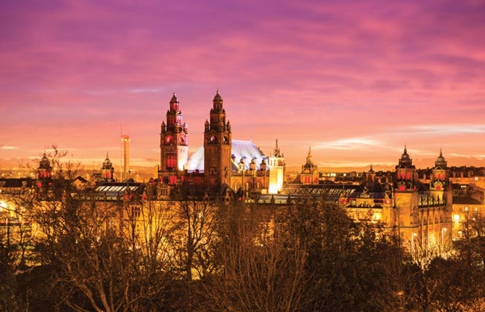 Kelvingrove museums silhouetted against a sunset sky