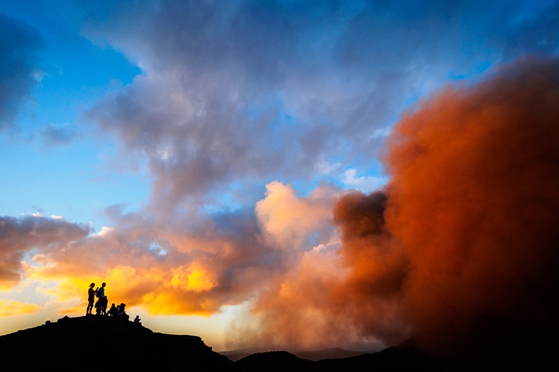 Tourists stand on Mt Yasur, Vanuatu