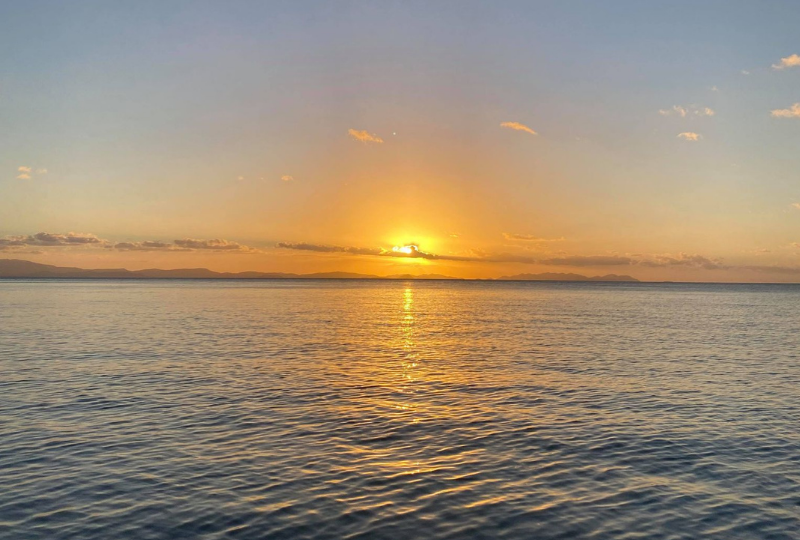 a view of the sunset across the waters in Whitsunday Islands