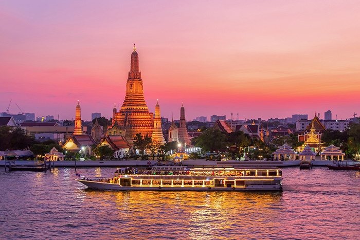 River cruise sailing past Wat Arun at sunset - why book a river cruise now