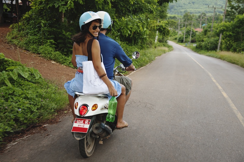 Couple riding scooter on road in Bali