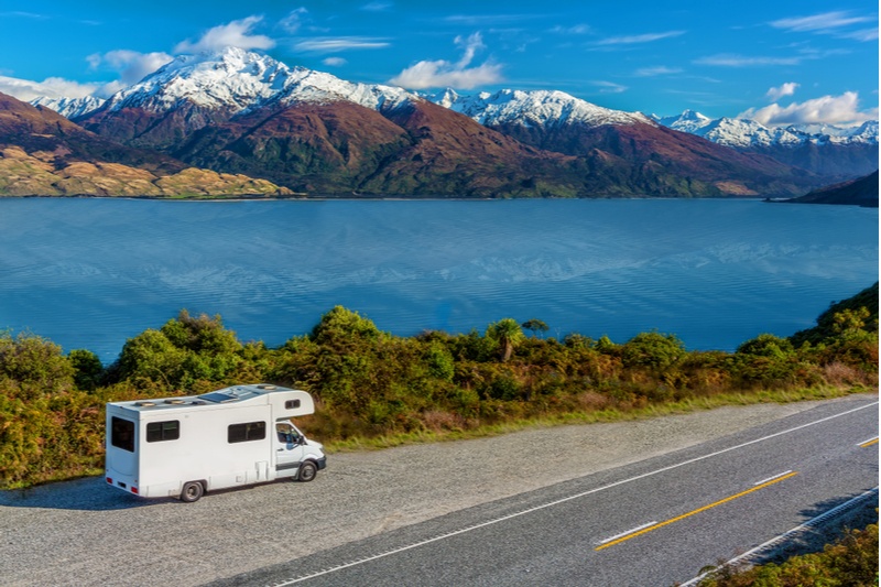 Campervan on the banks of Lake Wanaka with the Southern Alps in the background, South Island, New Zealand.
