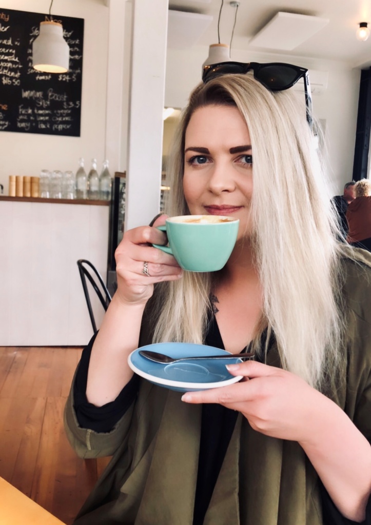 A woman drinks coffee.