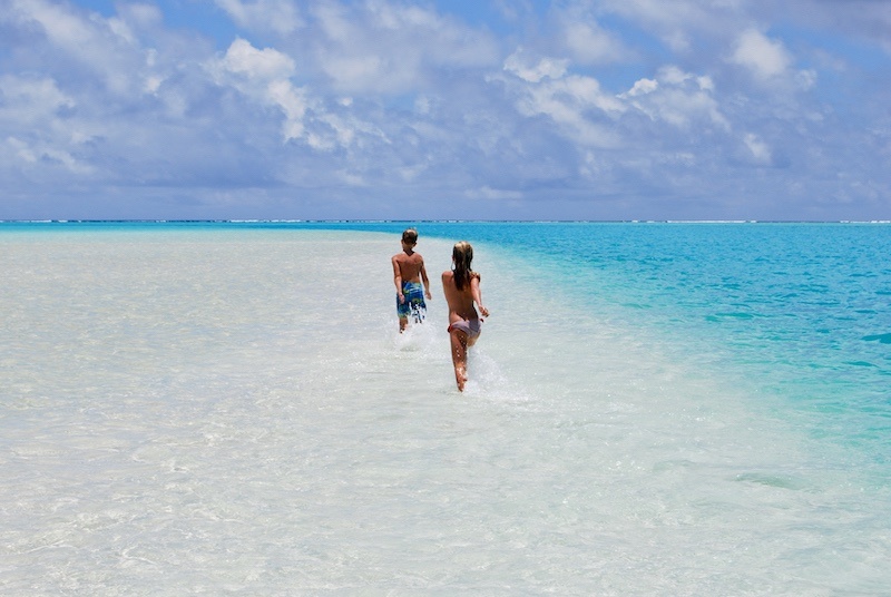 Kids love the shallow water in Aitutaki Cook Islands