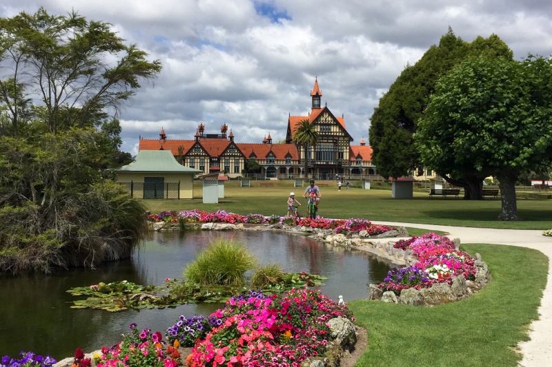 Riding bikes in the Government Gardens with the Rotorua Museum in the background