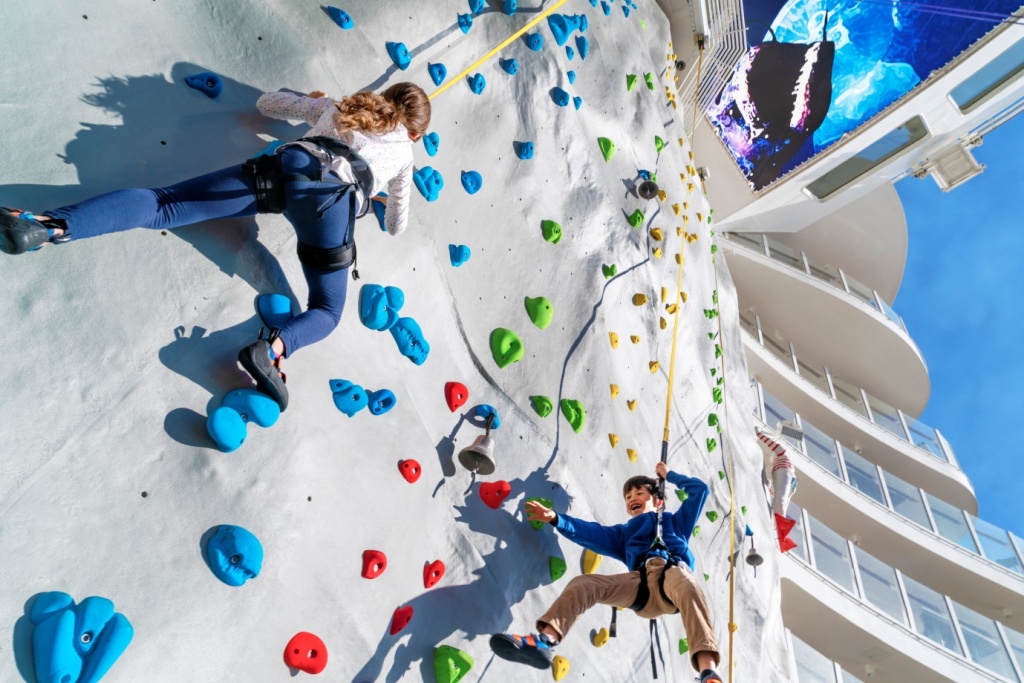 people rock climbing on wall on cruise ship