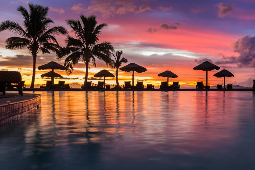 Calm resort pool at sunset Fiji