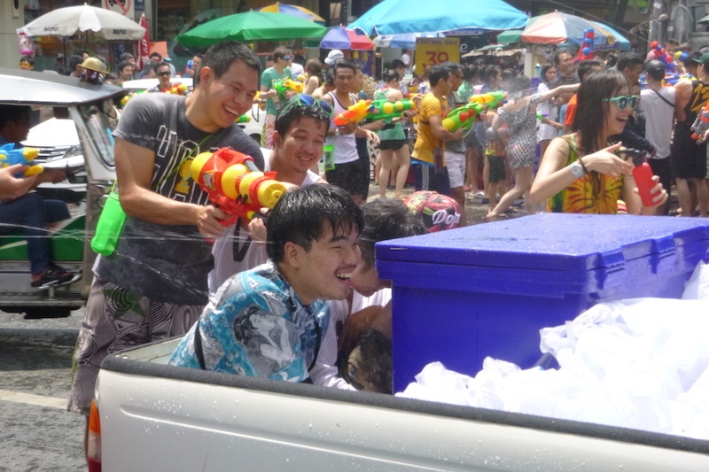 People spray a man on the back of a ute in the Songkran water festival, Bangkok.