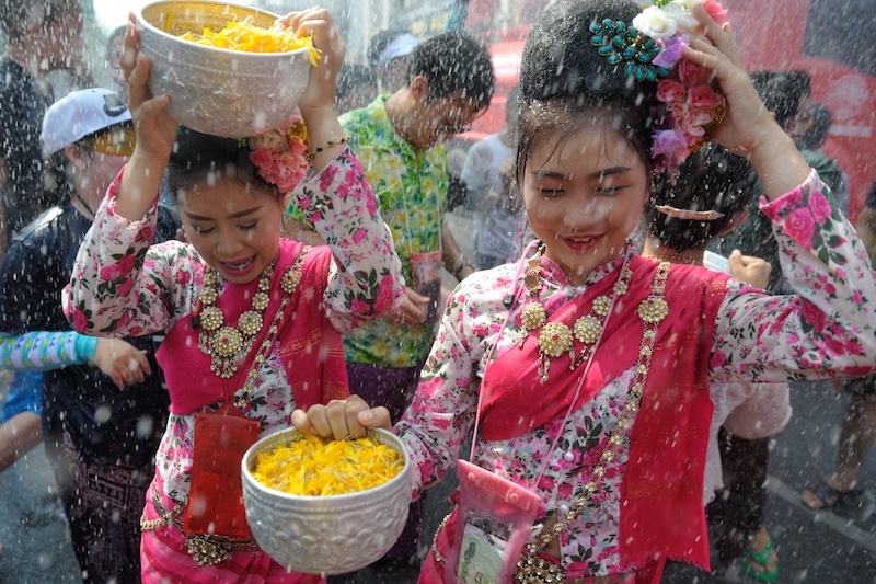 Thai women are splashed with water during Songkran Festival, Bangkok. 
