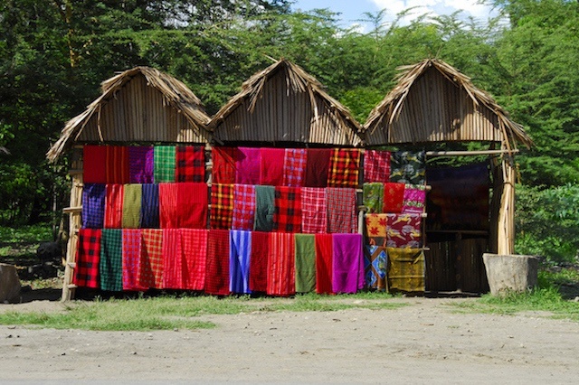 Shop with traditional multicolored Masai blankets on a roadside in Tanzania.