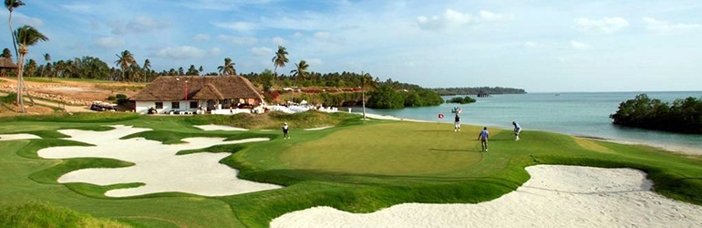People playing golf on a golf course next to a beach
