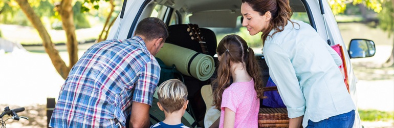 A family packing a car for a holiday