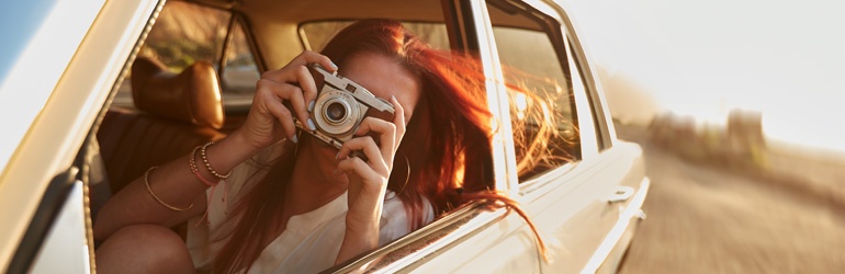 Lady in a car with a camera